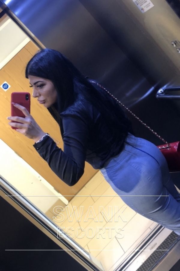 Monica rear selfie wearing blue jeans and black jacket